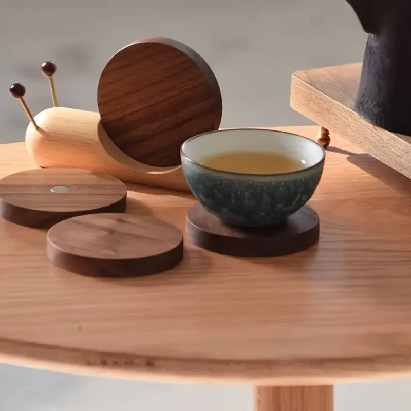 Tea bowl with wooden coasters on a wooden surface