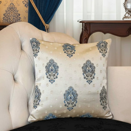 Decorative pillow with blue floral patterns on a beige sofa