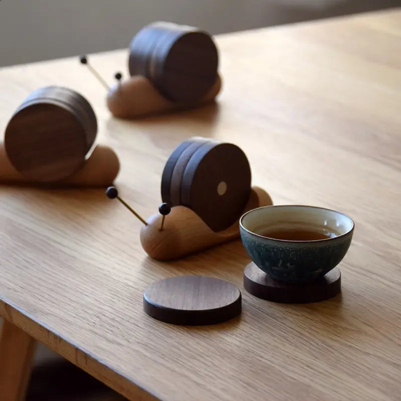 Wooden tea canisters and a teacup on a wooden surface