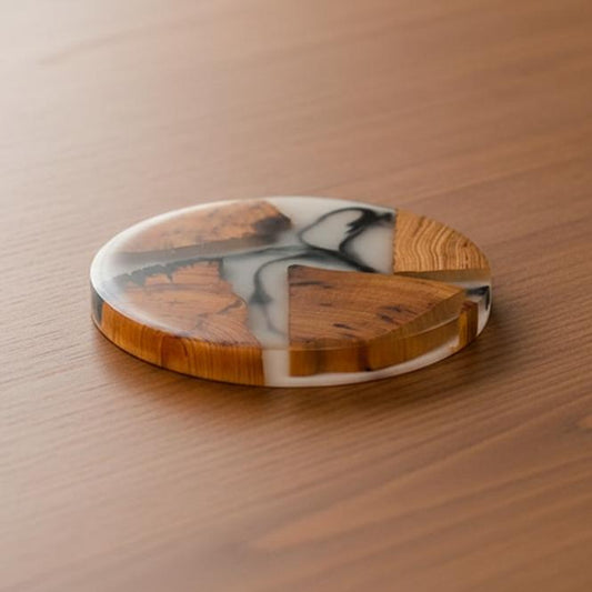 Round marble and wood coaster on a wooden surface
